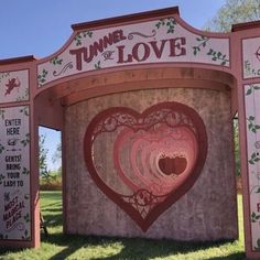 the tunnel of love sign is painted pink and red