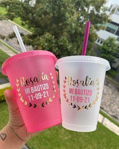 two plastic cups with straws in their hands