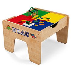 a wooden toy table with two different colored blocks and letters on it, including the name noah