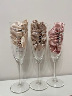 three wine glasses with bows are lined up