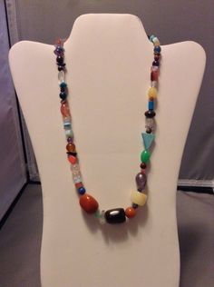 This funky avant garde necklace makes a great statement piece! It features many assorted gemstones, including (but not limited to) tiger eye, amethyst, opalite, mahogany obsidian, chalk turquoise, and carnelian. The length is adjustable and can measure from 21 1/4 inches to 23 1/4 inches. Unique Multicolor Crystal Necklaces With Stones, Unique Multicolor Crystal Necklace With Stones, Multicolor Necklaces For Jewelry Making In Various Shapes, Eclectic Beaded Healing Jewelry, Eclectic Beaded Jewelry For Healing, Eclectic Necklace, Multi Gemstone Necklace, Mahogany Obsidian, Multi Coloured Necklaces