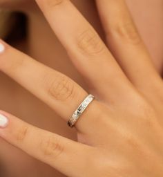 a woman's hand with a ring on it