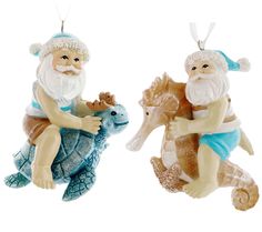 two ornaments depicting santa claus and a sea turtle are hanging from strings on a white background