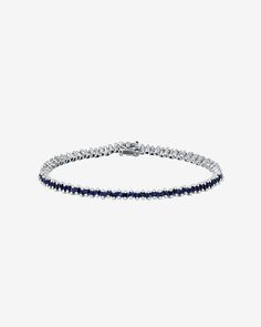 Embrace the refined charm of our Princess Mini Tennis Bracelet. This exquisite piece showcases offset princess-cut sapphires, each one carefully selected to enhance the bracelet's overall elegance. Featuring 3.20 carats of 1.5mm princess-cut dark blue sapphires, it offers versatility for stacking or stands out gracefully as a solo piece. Details 18k white gold 3.20 carats of 1.5mm princess-cut dark blue sapphires Bracelet measures 7 inches in length Box clasp with safety lock fastening 3mm width Classic Sapphire Tennis Bracelet With Prong Setting, Classic Sapphire Tennis Bracelet With Brilliant Cut, Sapphire Tennis Bracelet Fine Jewelry With Prong Setting, White Gold Sapphire Gemstone Tennis Bracelet, Sapphire Color Brilliant-cut Cubic Zirconia Bracelets, Elegant Sapphire Tennis Bracelet With Brilliant Cut, Luxury Sapphire Tennis Bracelet With Brilliant Cut, Classic Sapphire Gemstone Tennis Bracelet, Silver Sapphire Tennis Bracelet With Brilliant Cut