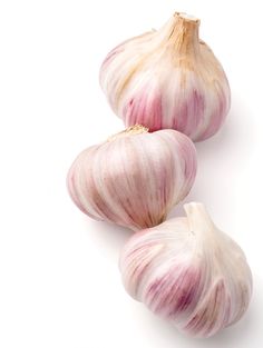 three bulbs of garlic on a white background