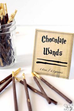 chocolate wands in a glass jar next to a sign