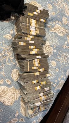 stacks of money sitting on top of a bed