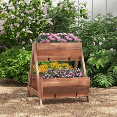 a wooden planter filled with lots of flowers