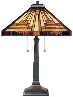 a table lamp with a stained glass shade on it's base and chain at the bottom