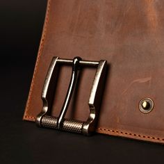 a leather wallet with a metal buckle on it