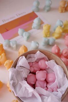 there are many small candies in a bowl on the table next to each other