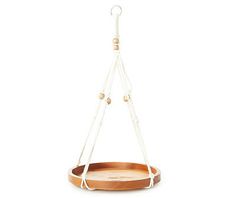 a wooden tray hanging from a white rope