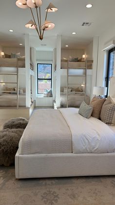 a large bedroom with bunk beds in the middle and carpeted flooring on both sides