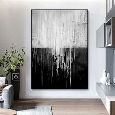 a black and white painting hanging in a living room