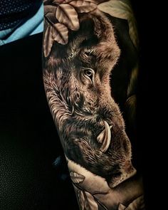 a man's arm with an animal tattoo on it