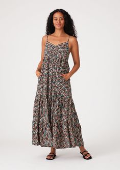 An ultra-flowy sleeveless summer maxi dress in a black and teal floral print. Floral print Relaxed, flowy fit Sleeveless Maxi length Tiered skirt V-neckline with scalloped edge Self-covered button front top Adjustable spaghetti straps Side pockets Flowy bohemian maxi dress A flowy silhouette adds an effortless touch to this bohemian chic maxi dress. Designed in a versatile black and teal floral print. The adjustable spaghetti straps allow for a customizable fit, while the scalloped edge trim add Fall Maxi Dress, Chic Maxi Dress, Fall Maxi, Chic Maxi Dresses, Maxi Dresses Fall, Bohemian Maxi, Bohemian Maxi Dress, Button Front Top, Black Floral Print