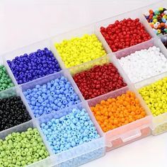 many different colors of beads in a plastic container