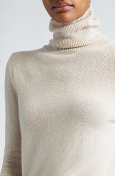 Supremely soft cashmere warms a fitted sweater knit in Italy with a tall turtleneck and deeply ribbed trim. Turtleneck Long sleeves Ribbed cuffs and hem 100% cashmere Dry clean Made in Italy Designer Clothing Elegant Fitted Sweater With Ribbed Cuffs, Elegant Fitted Turtleneck With Ribbed Cuffs, Elegant High Neck Turtleneck With Ribbed Cuffs, Cream Turtleneck With Ribbed Cuffs, Luxury Fitted Sweater With Ribbed Cuffs, Luxury Fitted Fine Knit Sweater, Elegant Cashmere Sweater With Funnel Neck, Classic Cashmere Turtleneck With Ribbed Cuffs, Fitted Cashmere Turtleneck In Chic Style