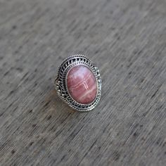 Gemstone - Rhodochrosite Gemstone Size - 12x16 mm oval Metal - Sterling Silver Ring Size - All sizes Available Natural pink rhodochrosite sterling silver handmade ring Rhodochrosite attracts love by opening up the heart chakras with its healing vibrations. It gives us the inner strength to take another chance at love because even if you fall, the Rhodochrosite crystal will always catch you. The ring can be customized on request and gemstone can be switched to any gemstone you want. Feel free to Oval Pink Opal Gemstone Rings, Oval Pink Opal Jewelry For Gifts, Oval Pink Opal Jewelry Gift, Pink Oval Spiritual Ring, Pink Oval Gemstones For Gift, Pink Oval Gemstones For Gifts, Rhodonite Gemstone Jewelry For Gift, Rhodonite Round Natural Stone Jewelry, Round Rhodonite Jewelry With Natural Stones