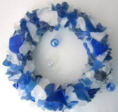 a blue and white bracelet is hanging on the wall next to a glass bead