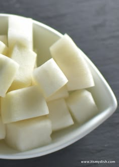 cubes of cut up food in a white bowl