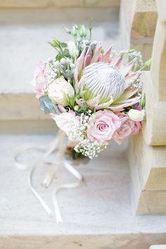 a bouquet of flowers sitting on the steps