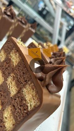 chocolate cake with icing and decorations on display in a bakery shop or store window