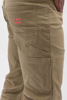 We answered the call, and our carpenter pant has returned with updates to enhance your work day. We added a double back pocket, redesigned the utility pockets and replaced metal rivets with secure bartacks for when you’re on the job. What remains constant is the extra roomy fit and a bit of stretch to keep you in hi-level comfort.Stretch Canvas- Rugged Tan• Front scoop pockets and enlarged coin pocket.• Oversized back pockets with left side double pocket.• Extra back belt loops.• Stacked side ut Mens Pleated Trousers, Khaki Work Pants, Wicked Fashion, Work Pants For Men, Mens Work Pants, Its A Mans World, Work Gear, Work Jeans, Utility Pockets