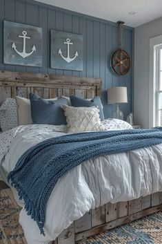 a bedroom with blue walls and white bedding