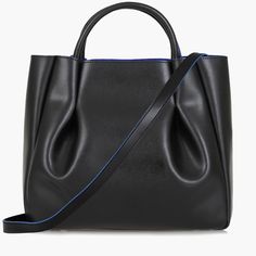 The Amalfi Large Leather Tote Bag exudes an effortless sophistication and timeless elegance. Its generous size and pleated design make it the ideal companion for any outfit, from the most formal of work settings, to a relaxed day at the beach. Crafted with luxurious Italian leather, this piece promises an effortless style that will turn heads everywhere you go. Black Shoulder Bag With Rolled Handles For Work, Formal Black Satchel With Rolled Handles, Black Satchel With Rolled Handles For Formal Events, Black Satchel With Rolled Handles For Formal Occasions, Elegant Structured Bag For Formal Occasions, Elegant Structured Formal Bag, Elegant Satchel Bag With Rolled Handles, Elegant Satchel Shoulder Bag With Rolled Handles, Versatile Black Shoulder Bag With Rolled Handles