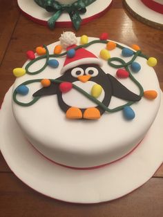 a decorated cake with a penguin on top