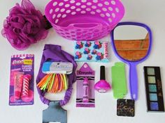 the contents of a purse laid out on a white table with pink and purple accessories