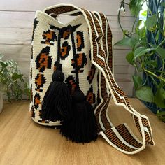 Description: Animal Print Retro Handwoven Crossbody Bag Brand New! I Designed And Commissioned This Bag From Wayuu Woman. The Wayuu Are An Indigenous Tribe In Colombia Known For Their Beautiful Handwoven Work, And This Bag Represents About A Week's Worth Of Work. Details: Handmade Item- Handwoven Color: White, Tan, Orange, & Black Material: 100% Acrylic Width: 11.5" Height: 11" Total Length: 25" Style: Hippie/ Bohemian /Retro/ Classic Mochila / Animal Print White Crochet Bucket Bag With Adjustable Strap, Handmade White Bucket Bag For Everyday, White Crochet Satchel With Braided Handles, White Crochet Travel Bag With Braided Handles, White Crochet Bag With Braided Handles For Travel, White Handmade Bucket Shoulder Bag, White Handmade Shoulder Bucket Bag, Handmade White Shoulder Bucket Bag, White Crochet Bucket Bag With Braided Handles