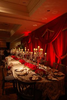 a long table is set up with candles and place settings for formal dinnereons