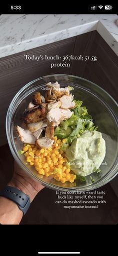 a person holding a glass bowl filled with food