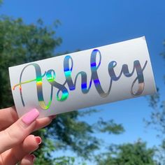 a person holding up a piece of paper with the word holliey on it