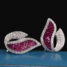 Dazzling ruby and diamond earrings with elaborate design.Item #JP-E0017Metal: 18K White GoldWeight: 9.2 GramsDiamond Weight: Approximately 2.0 CTSDiamond Color: GDiamond Clarity: VS2Gemstone Weight: Approximately 5 ct. rubyMeasurements: 26.20 x 18.52 mmLayaway: For your convenience, we will be happy to provide layaway payment options. Please contact us to work out a layaway plan which best suits your needs. All layaway purchases are final sale.All domestic and international shipments are shipped Luxury Diamond Earrings With Prong Setting, Luxury Red Brilliant Cut Earrings, Fine Jewelry Ruby Diamond Earrings, Luxury Ruby Earrings With Prong Setting, Ruby Diamond Earrings Fine Jewelry, Luxury Red Diamond Earrings, Ruby Gemstone Diamond Earrings In Fine Jewelry Style, Ruby Gemstone Diamond Earrings For Formal Occasions, Ruby Diamond Earrings In Fine Jewelry Style