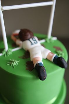 a cake with a soccer player laying on it