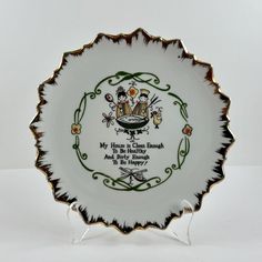 a white and green plate with an image of two people on the front, one holding a baby carriage