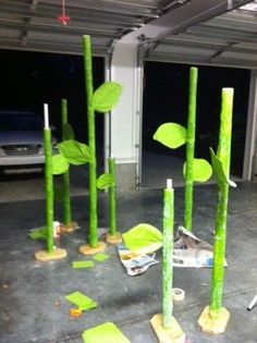 some green sticks with leaves on them in a parking garage