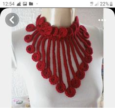 a red crocheted necklace on a mannequin