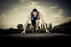 a man is doing push ups on a race track