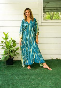 "Add a touch of unique style to your wardrobe with our Hand-Dyed Kaftan Dress! This stunning dress is made from 100% breathable and comfy rayon fabric, ensuring maximum comfort all day long. Using the traditional Shibori method, each dress is carefully hand dyed, resulting in a one-of-a- kind masterpiece. The intricate patterns and vibrant colors make this dress a true work of art. The kaftan dress comes in a versatile one size fits most (M-3XL), making it extremely comfortable for a wide range Green Batik Print Dress For Festival, Tie Dye Natural Dye Dress For Beach Cover-up, Beach Cover-up Tie Dye Dress With Natural Dye, Tie Dye Natural Dye Dress For Beach, Green Festival Dress With Batik Print, Green Batik Print Maxi Dress For Beach, Green Batik Print Dress For The Beach, Bohemian Hand Dyed Blue Dress, Hand Dyed Blue Bohemian Dress