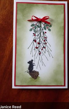 a handmade christmas card with an image of a bear and pine cone on it