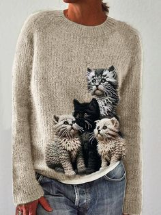 a woman wearing a sweater with cats on it