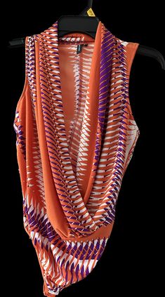 an orange and purple scarf hanging on a hanger