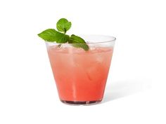 a pink drink with mint garnish in a tall glass on a white background