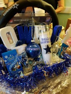 a basket filled with blue and white items on top of a table next to a steering wheel