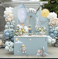 an outdoor birthday party with balloons and decorations