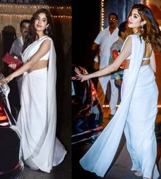 two women in white outfits standing next to a car and one is holding a purse